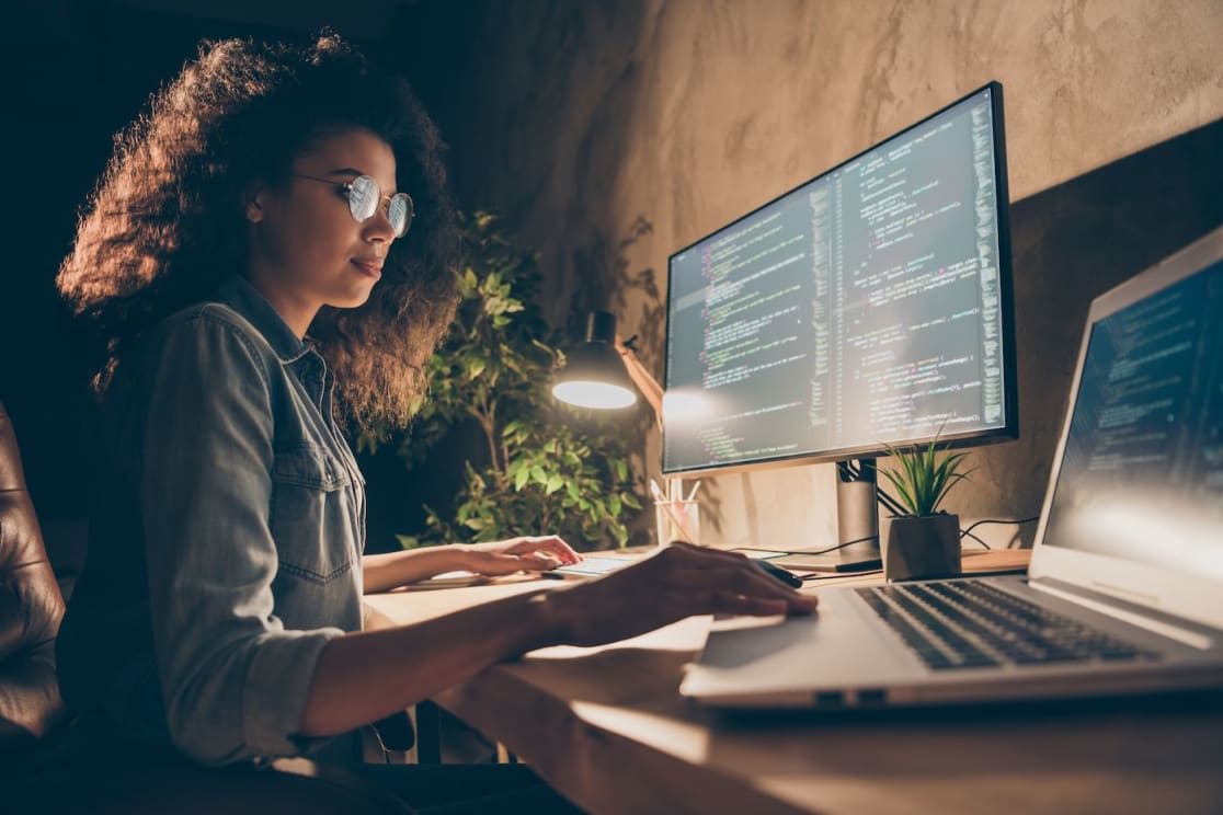 Female programmer with desktop.  